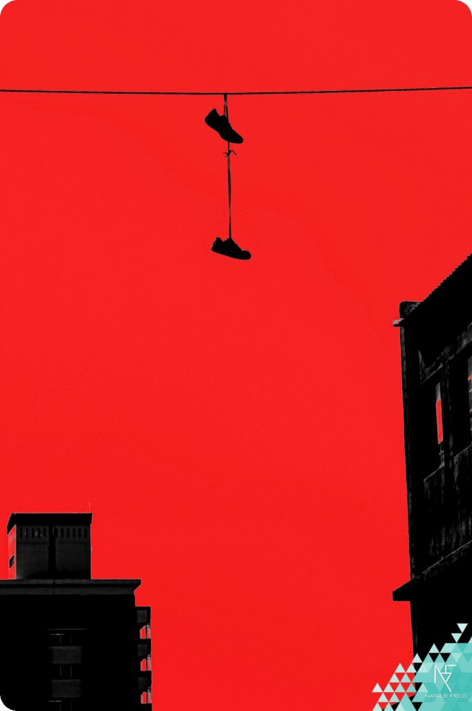 Shoes on a wire Johannesburg CBD inner city with red colour blocking by Natalie Field Photography